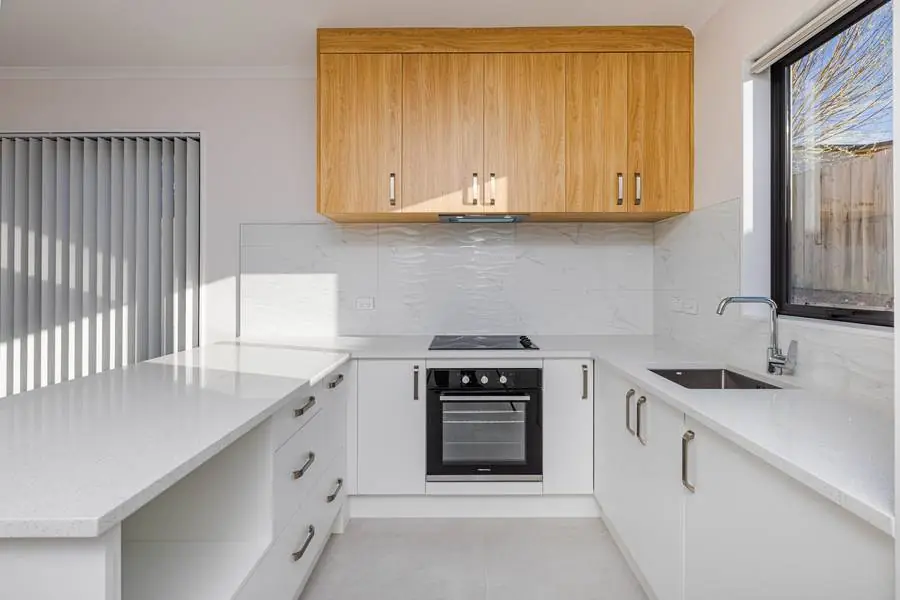 Tasman Drive — Kitchen with timber-tone joinery